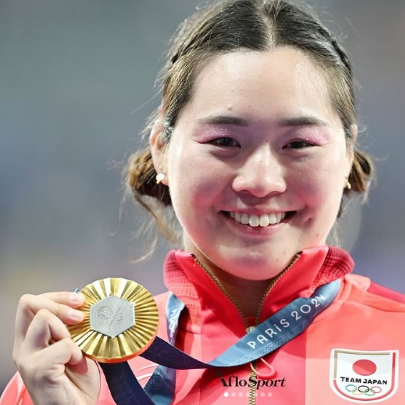 2024パリオリンピック時金メダルを首にかけ笑顔の北口榛花選手の画像