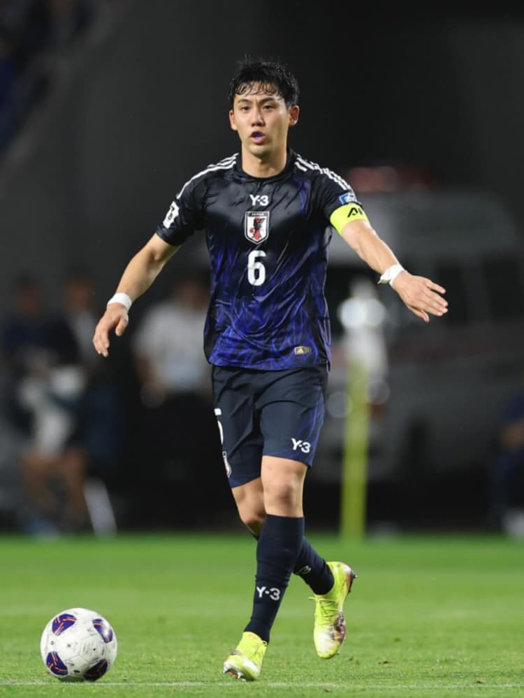 日本代表の濃紺のユニフォーム(Y-3コラボレーションモデル)を着用し、黄色いキャプテンマークを腕に巻いてピッチに立つ遠藤航選手。